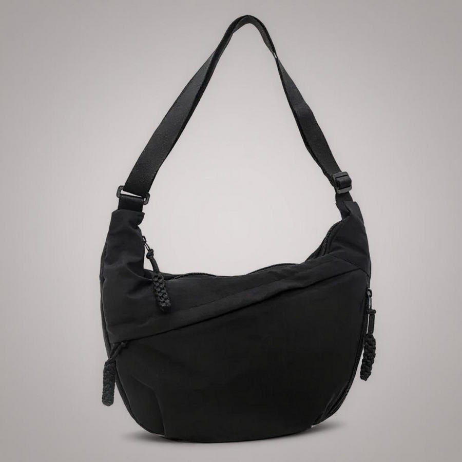 Black crescent shoulder bag with zip pockets, front product view.