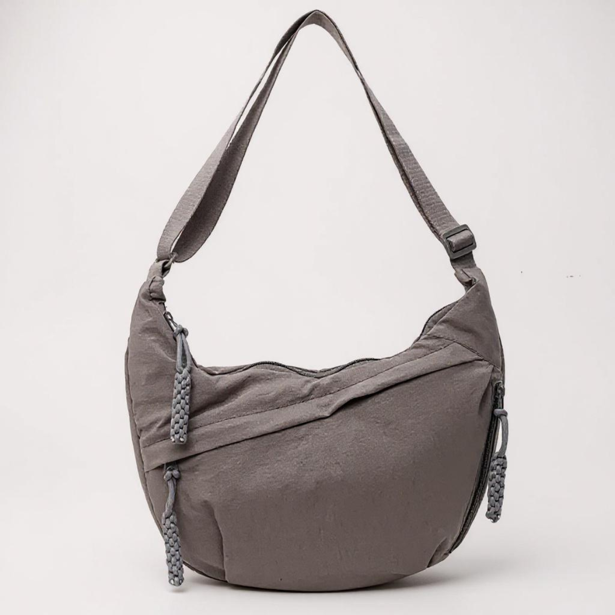 Grey crescent shoulder bag with zip pockets, front product view.