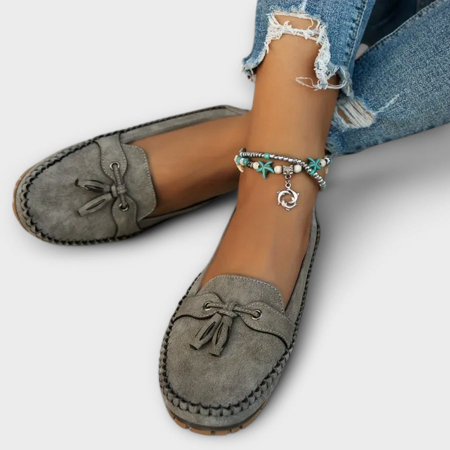 Women's loafers with tassel detailing, a slip-on design and a closed toe