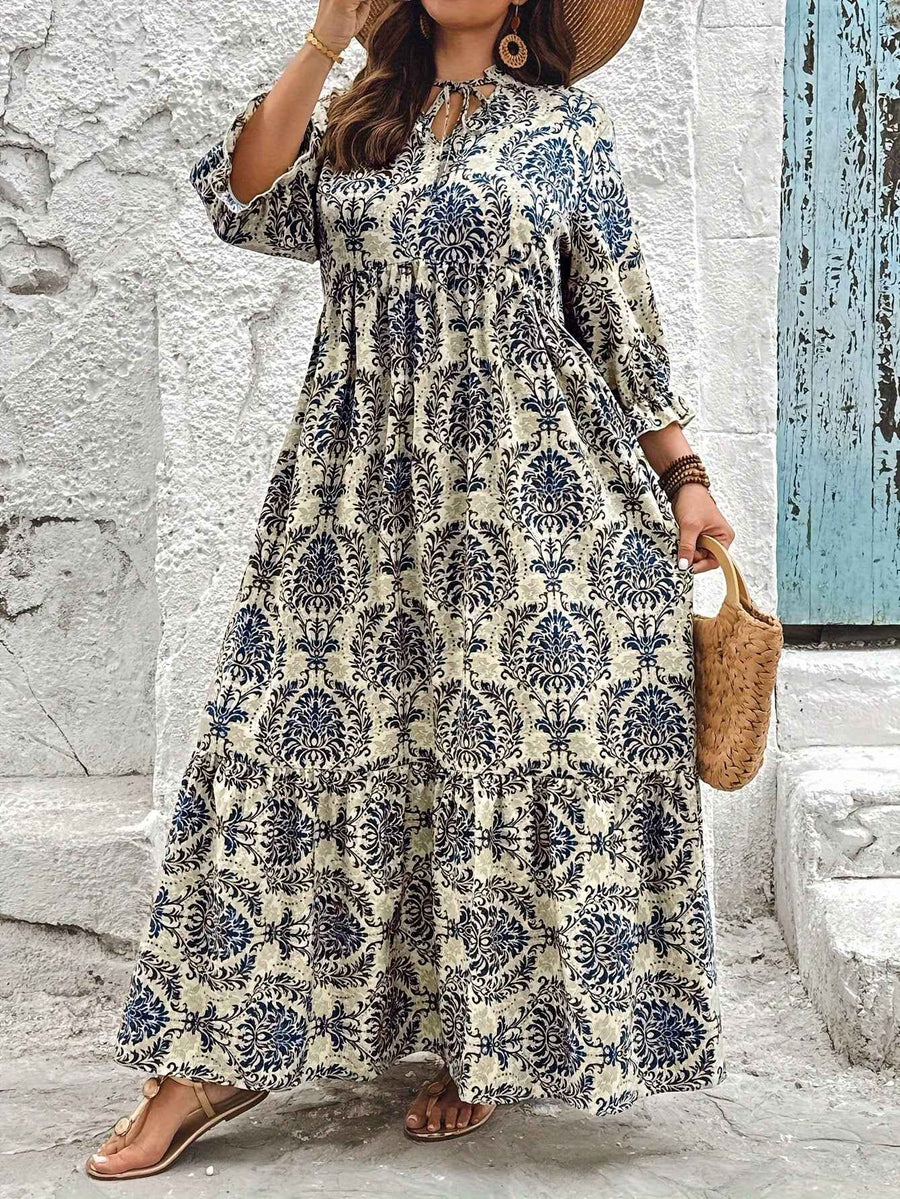 Women's maxi dress with an ornamental pattern, a notched neckline and elbow-length sleeves