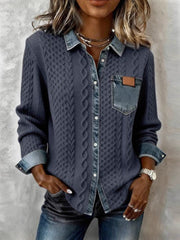 Cable-knit cardigan with denim-effect collar, button placket and chest pocket, front view.