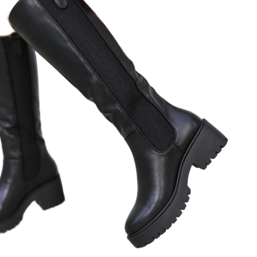 Women's knee-high boots with a chunky tread sole, an elastic side panel and a knee-high shaft