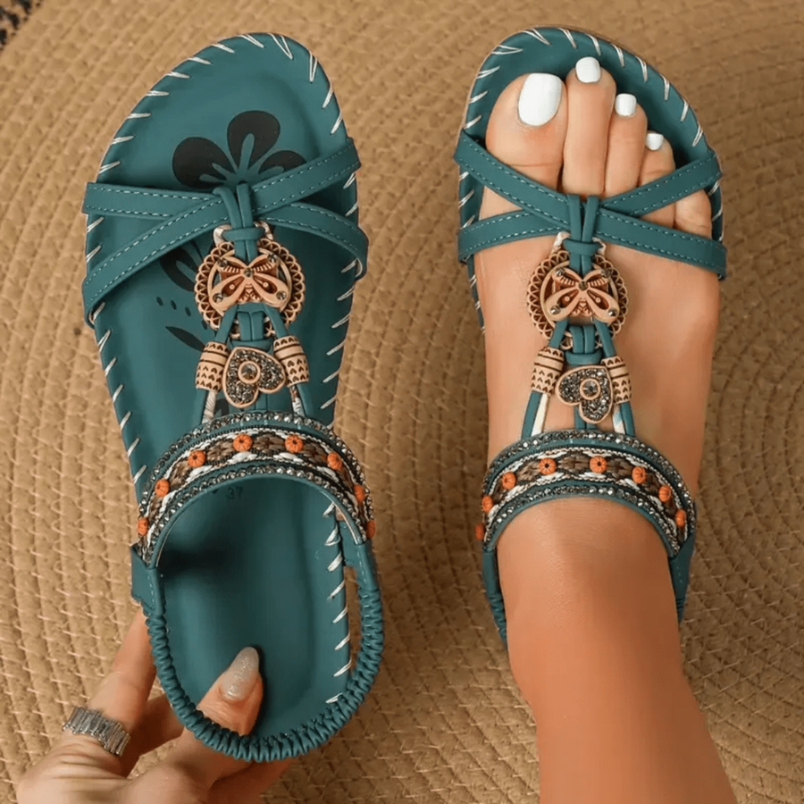 Women's sandals with a T-shaped strap, decorative embellishment and an open toe
