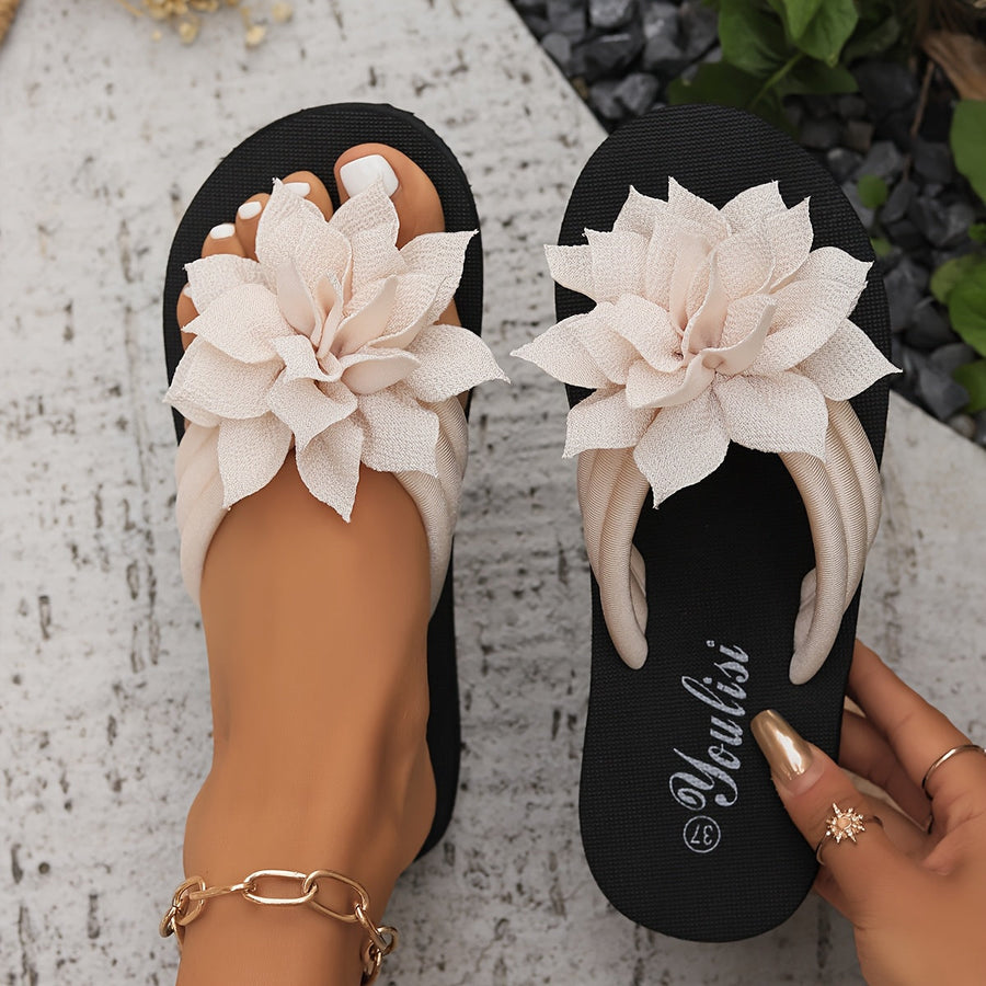 Women's sandals with flower appliqués, a toe-post design and a slip-on design