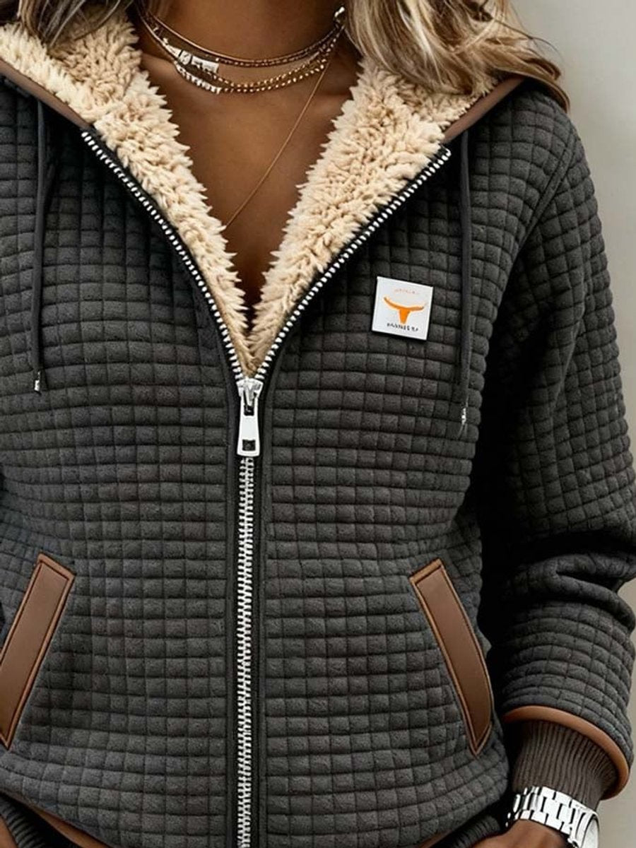 Close-up of the jacket hood lining and front zip, with the grid-textured body visible.