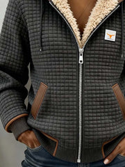 Grid-textured jacket showing the front zip, angled pockets and contrast cuff edging.