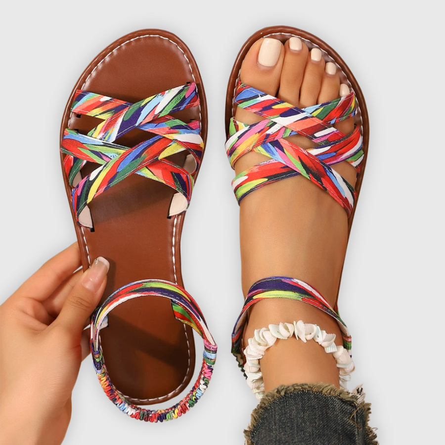 Women's sandals with patterned straps, crossing straps and an ankle strap