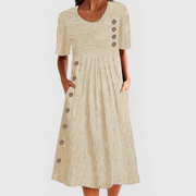 Women's midi dress with decorative buttons, elbow-length sleeves and side pockets