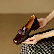 Women's loafers with a penny-style strap, a slip-on design and a closed toe