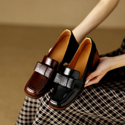 Women's loafers with a penny-style strap, a slip-on design and a closed toe