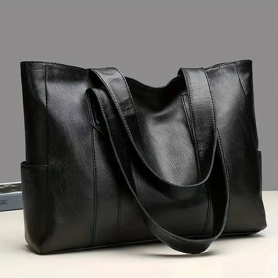 Women's handbag with a tote silhouette, twin carry handles and a rectangular shape
