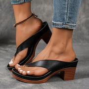 Women's heeled sandals with a toe-post design, a platform sole and an open toe