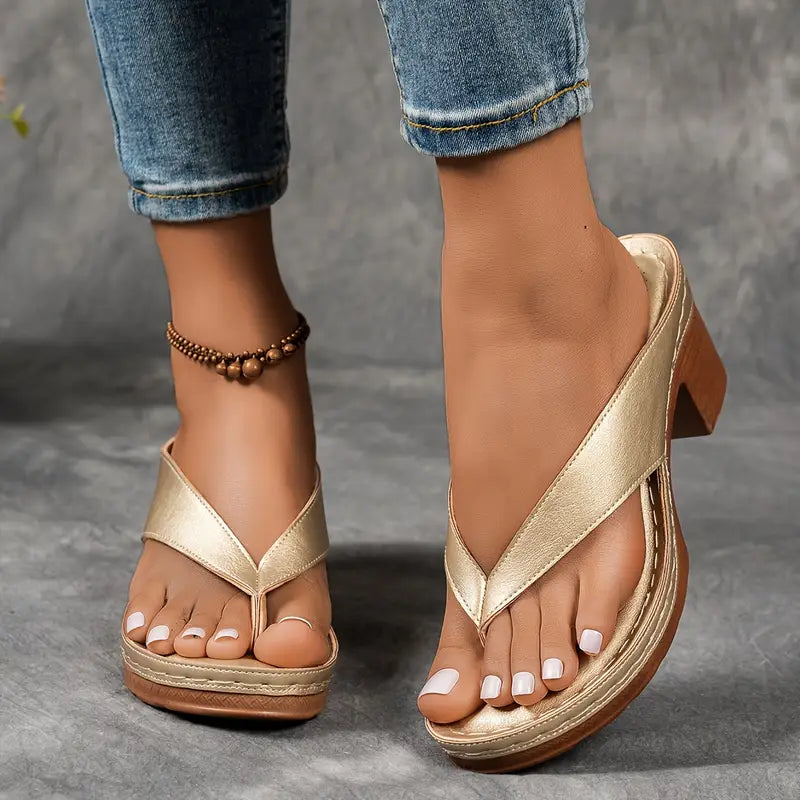 Women's heeled sandals with a toe-post design, a platform sole and an open toe